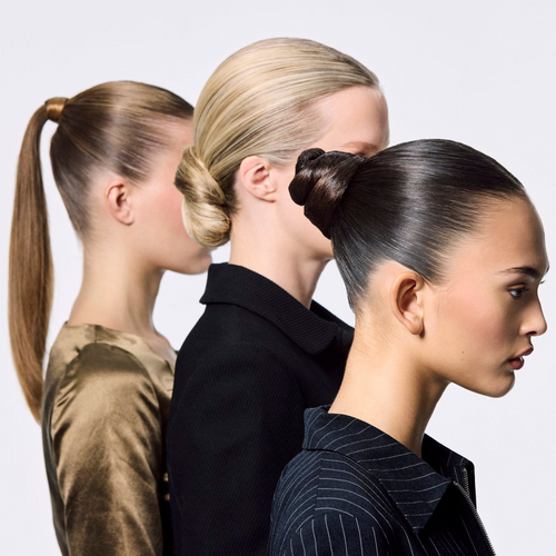 Three women with styled hair in ponytails against a plain background
